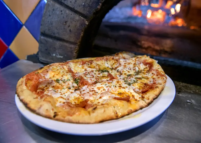 Sugar Wood Fired Bistro signature dishes Margherita Pizza, Fig and Prosciutto Pizza, Wood Fired Salmon, Meatloaf